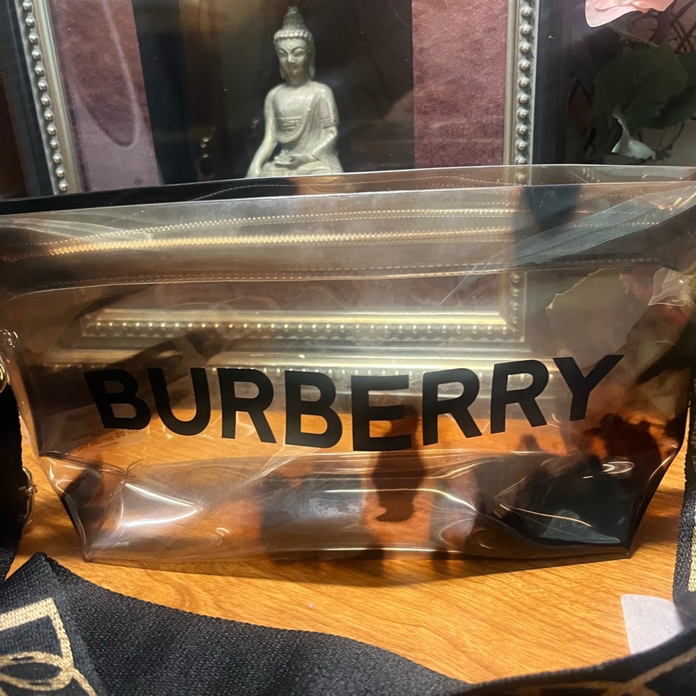 Burberry transparent bag off brand strap and tassel for additional charm.